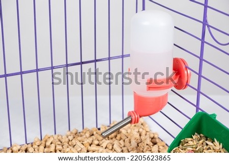 Drinker for rodent, rabbit, degu, chinchilla, guinea pig and rat in a cage.