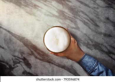 Drinking Beer Alone In Bar, Hand Holding Glass Of Beer On Modern Marble Table, Top View