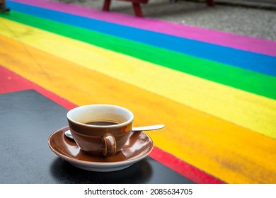 Drinking coffee at table in a rainbow street. Equal rights for LGBT community street art. Skólavörðustígur, Reykjavik - Iceland.