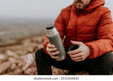 Drinking coffee from a thermos, while hiking - Powered by Shutterstock