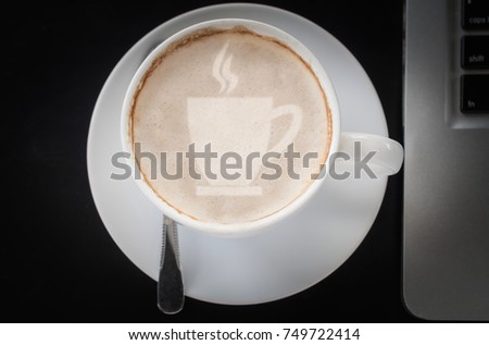 Drinking coffee and using laptop