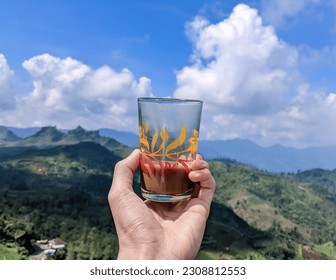 drinking coffee while looking at the beauty of nature which is very cool

