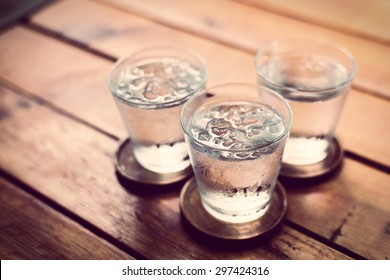 Drinking Cold Water Into A  Three Glass Placed On The Wooden Table.