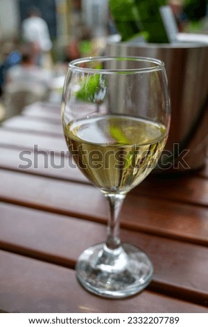 Drinking cold white wine with friends on outdoor terrace, summer vacation, close up