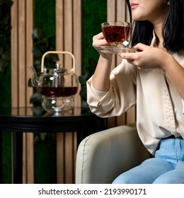 Drinking a fresh made black tea from transparent cup