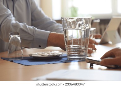 drinking a glass of water for fluid supply and hydration