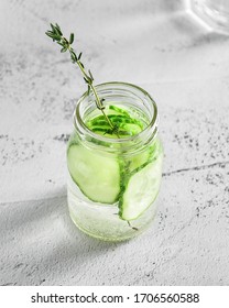 
Drinking refreshing cucumber lemonade with thyme in a jar