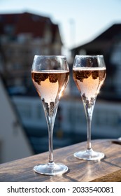 Drinking Of Rose Champagne Sparkling Wine From Flute Glasses On Outdoor Terrace In France In Sunny Day