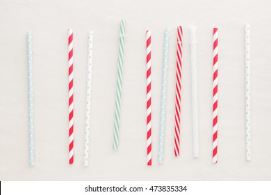 Drinking straws background. Different drinking straws over white background.  Top view, blank space
