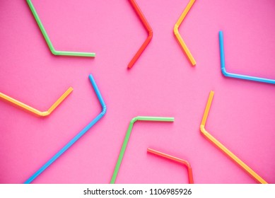 Drinking straws on pink background. Summer cocktail party, fun and happy vacation concept.