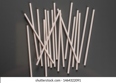 Drinking straws for party on gray background. Top view of colorful paper disposable eco-friendly straws for summer cocktails. Drinking paper colorful straws for summer cocktails.