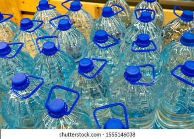 Drinking water bottles in a store. Batch of plastic bottles of water.