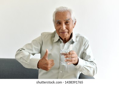 Drinking Water Is Good Healthy Habit For Old Man, Elderly Smiling Asian Man Show Thumb Up To Glass Of Purified Water, Senior Healthcare Concept.