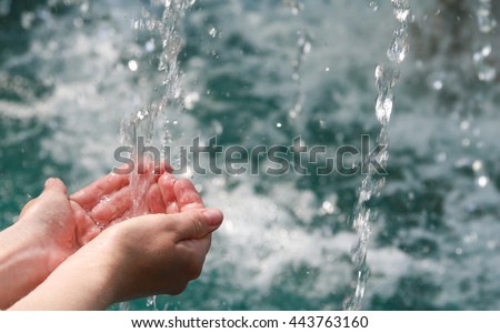Drinking water & natural water in the hands.