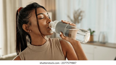 Drinking water, yoga or Indian woman in home with health, fitness or wellness for natural hydration. Thirsty female person, tired or healthy girl with liquid bottle after pilates to detox or relax - Powered by Shutterstock