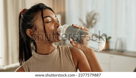 Drinking water, yoga or Indian woman in home with health, fitness or wellness for natural hydration. Thirsty female person, tired or healthy girl with liquid bottle after pilates to detox or relax