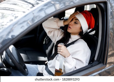 Drinking at the wheel. Drunk woman on new year's eve. You can't drive a car and drink alcohol at Christmas Eve