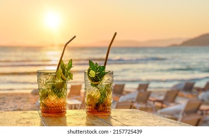 drinks with blur beach and sunset in background - Powered by Shutterstock