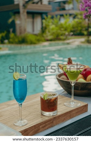 Drinks near rocky beach and pool 