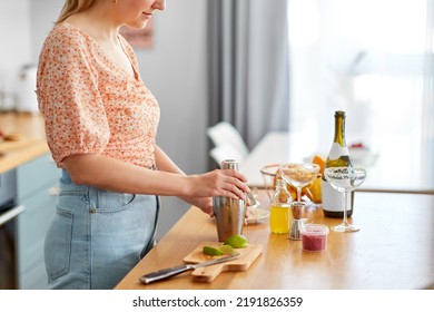 Drinks And People Concept - Close Up Of Woman With Shaker Making Cocktail At Home Kitchen