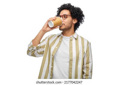 drinks and people concept - young man in glasses drinking takeaway coffee from paper cup - Powered by Shutterstock