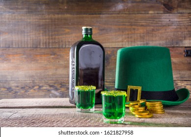 Drinks For St. Patrick's Day Party. Good Luck Leprechaun Shot Cocktail. Green Strong Drink In A Shot Glass With Gold Decor.