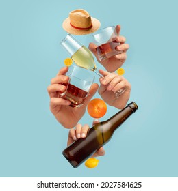 Drinks of your choice. Modern composition in magazine style with human hands holding glasses for alcohol drinks over blue background. Copyspace for ad, offer