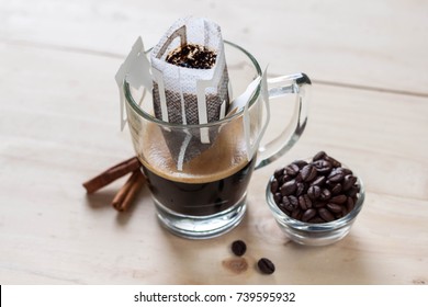 Drip Or Brewed Coffee On Wooden Texture, Paper Dripping Bag On A Cup