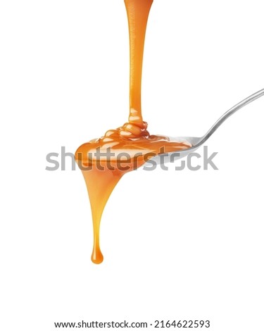  drip of caramel in a spoon on a white background