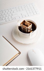 Drip Coffee Bag On The Table With Computer Keyboard And Mouse