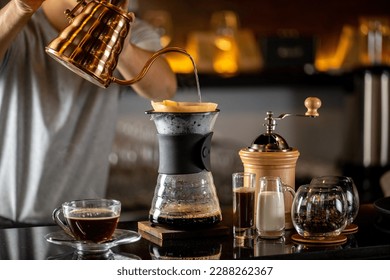 drip coffee, Barista making drip coffee by pouring spills hot water on coffee ground with prepare filter from copper pot to glass transparent chrome drip maker on wooden table in cafe shop - Shutterstock ID 2288262367
