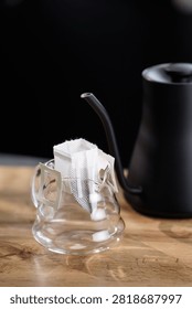 Drip coffee closeup setup with disposable pour over bag and glass server.