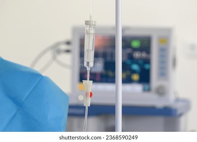 A drip with saline solution in the operating room close-up. Syringe pump with blurred medical equipment background.
Intravenous fluid infusion for a patient with blood loss during surgery.