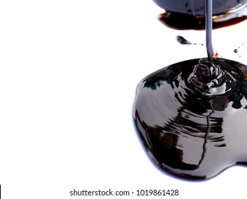 Dripping Black Treacle Or Molasses Isolated On White Background. Unrefined Sugar Syrup. - Selective Focus.