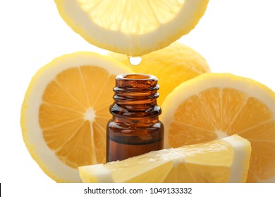 Dripping Citrus Essential Oil Into Bottle On White Background