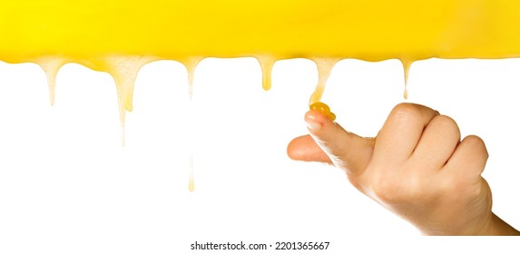 Dripping Honey On The Finger Of A Child's Hand, Liquid Caramel.