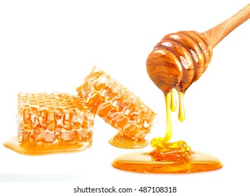 dripping honey on honeycomb isolated on white background