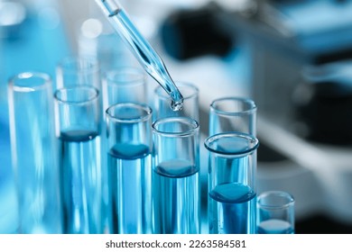 Dripping liquid from pipette into test tube in laboratory, closeup - Shutterstock ID 2263584581
