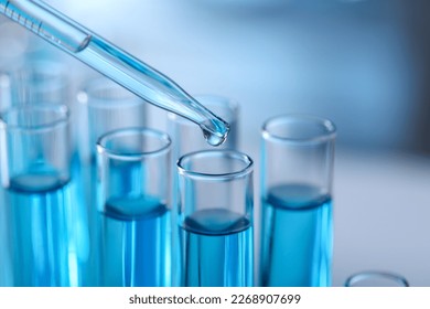 Dripping liquid from pipette into test tube in laboratory, closeup - Shutterstock ID 2268907699