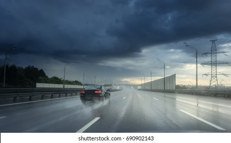 Drive Car In Rain On Asphalt Wet Road. Clouds And Sun.