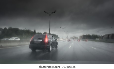 Drive Car In Rain On Asphalt Wet Road. Black Clouds.