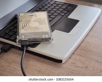 The drive is connected to a notebook computer on a wooden desk. With the concept of keeping information in the trade, it is important to the business.