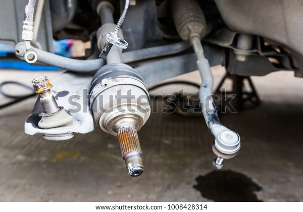 Drive shaft of car and abs sensor of\
brake cable remove for service in the car repair shop\
