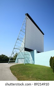 Drive In Theater Movie Screen Against A Sunny Blue Sky.