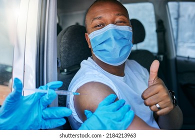 Drive Thru Covid And Corona Virus Vaccine Site As A Public Service For The People. Man Giving Thumbs Up And Endorsing The Jab While Wearing A Mask To Avoid Infection, Approving Being Vaccinated