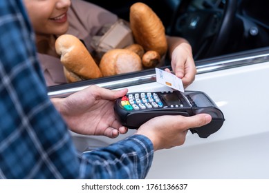 Drive Thru Service, Woman Buying Fresh Food Product And Pay With Credit Card Without Leaving The Car