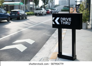 Drive thru sign with shop background.