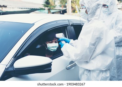 Drive Thru Test Covid19 Fast Track.Medical Worker In Protective Suit Screening Driver To Sampling Secretion To Check For Corona Virus