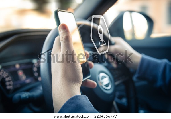Drive using smartphone.\
Automotive technology concept. Infotainment, navigation\
communication device