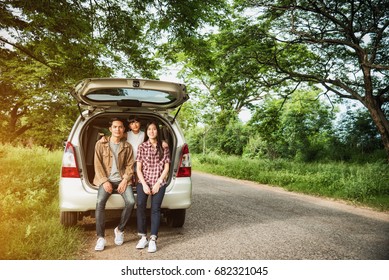 Drive In The Vacations Family; Asian Family Are Happy Sitting In The Open Trunk Of A Car;  Travel Nature Trip.